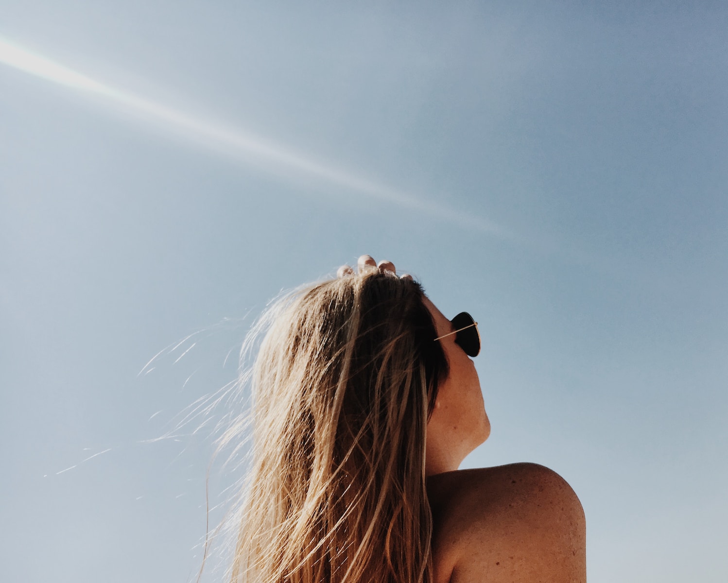 woman wearing gold framed Aviator sunglasses