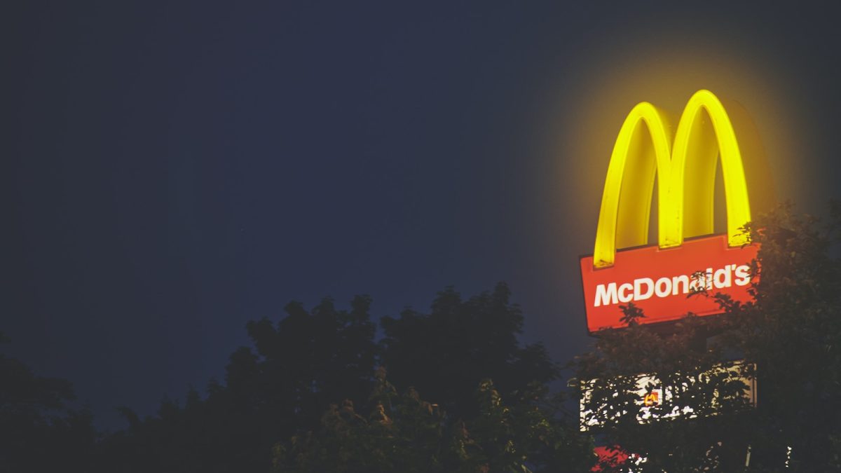 a sign with a light in the background