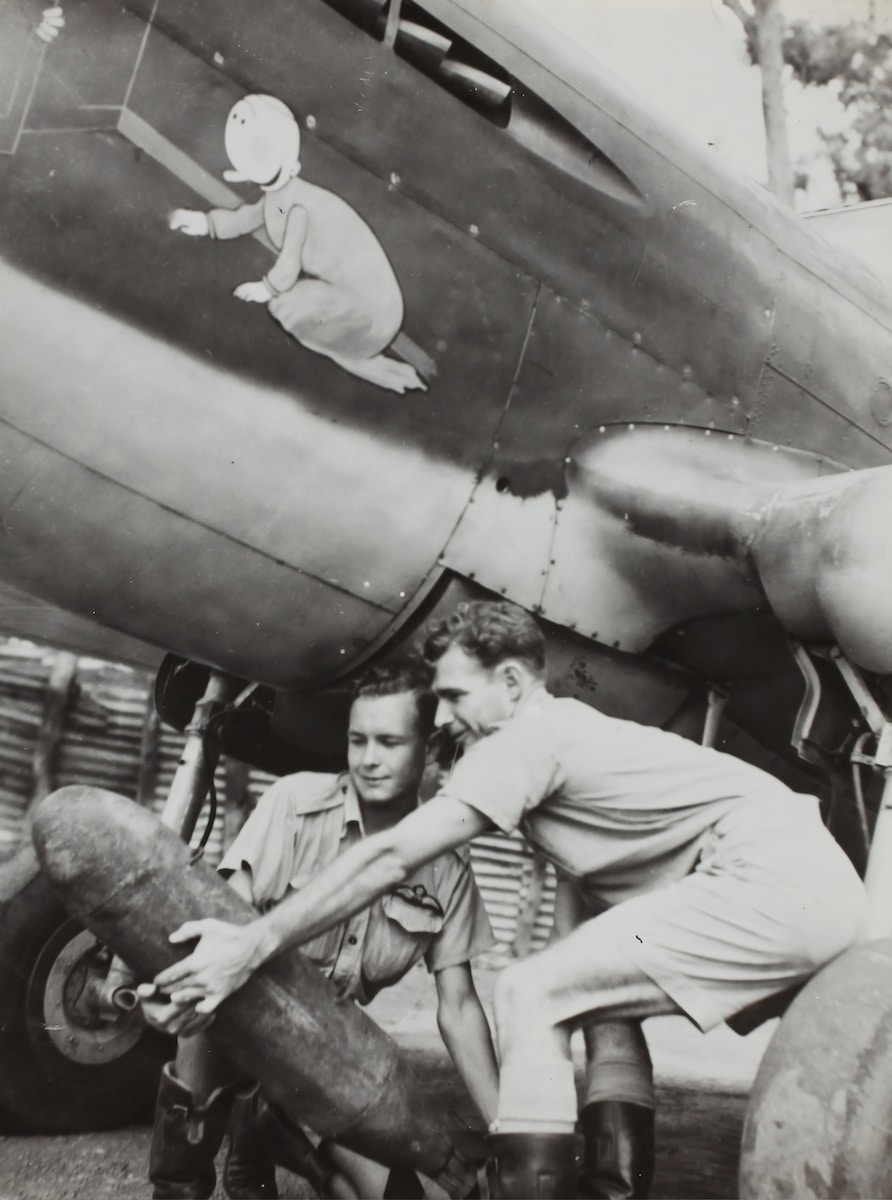 two person carrying plane bomb