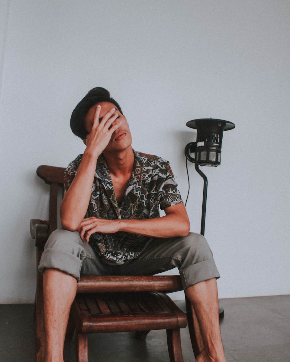 Man Sitting on Wooden Chair