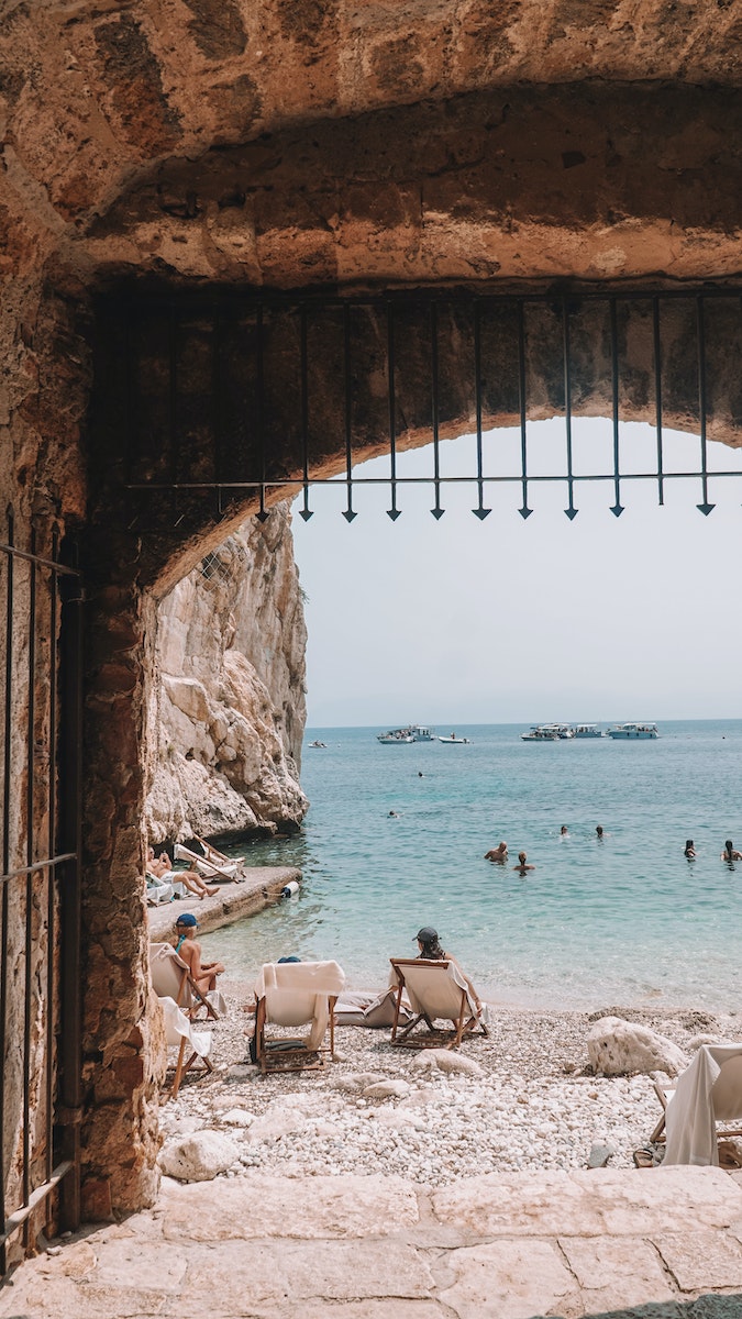 View of the Beach from a Stone Gate of a Castle