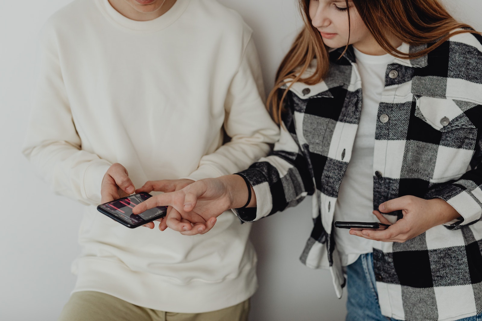 Young Couple Looking at Their Smart Phones