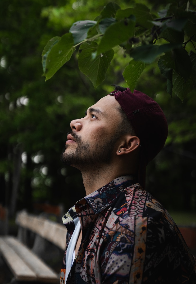 a man standing under a tree looking up