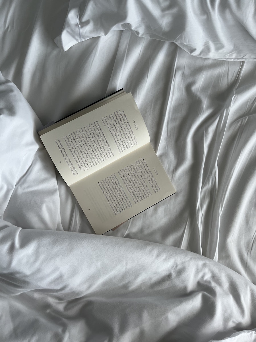 Photo of an Open Book on a White Textile