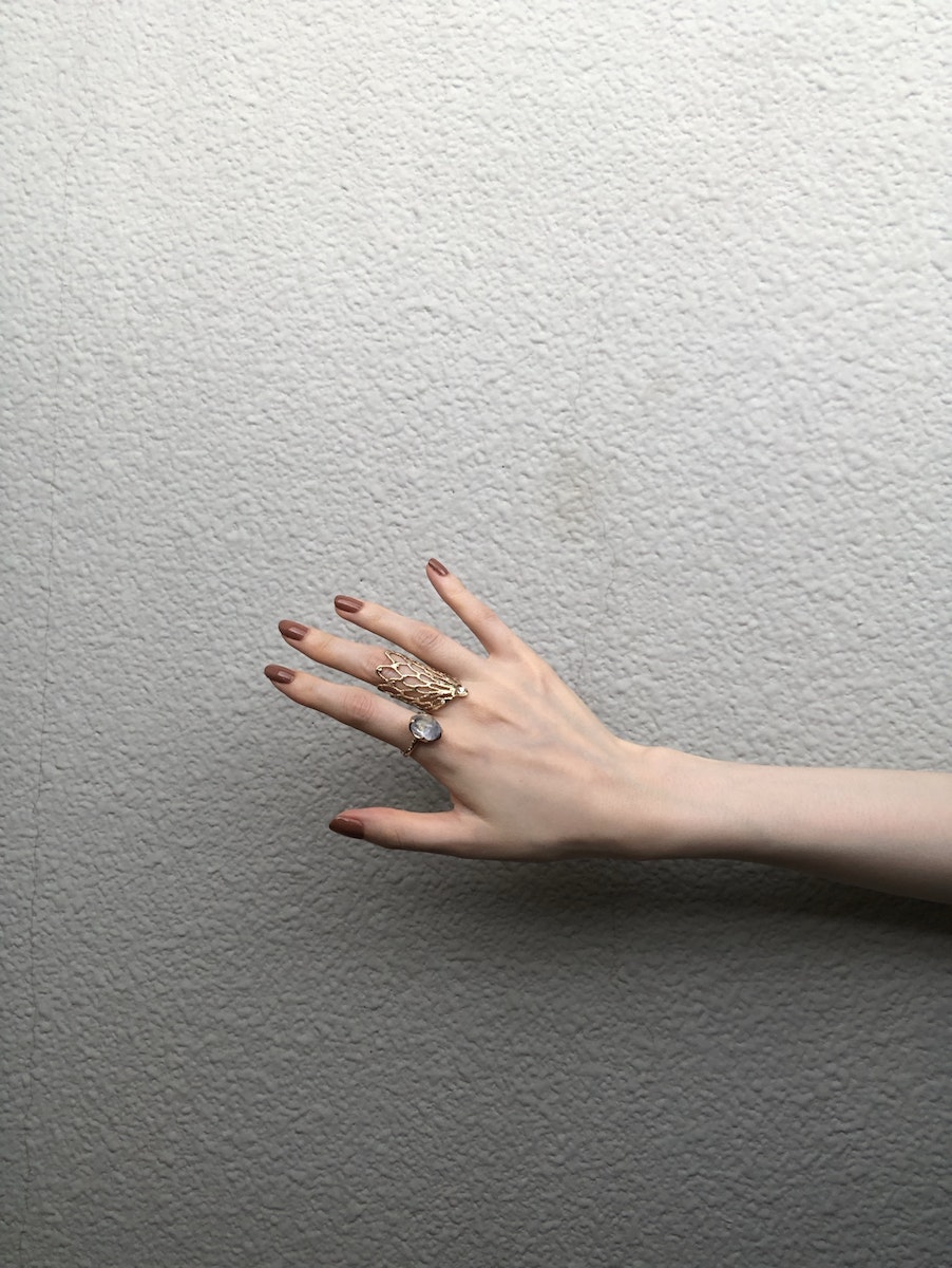 A Person with Brown Manicured Nails Wearing Rings