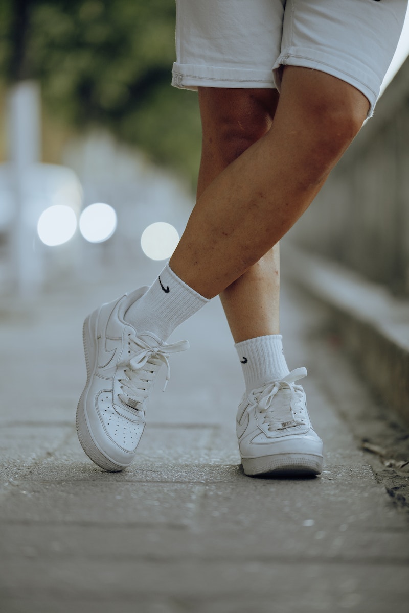 Close-up of Man in White Trainers and Shorts