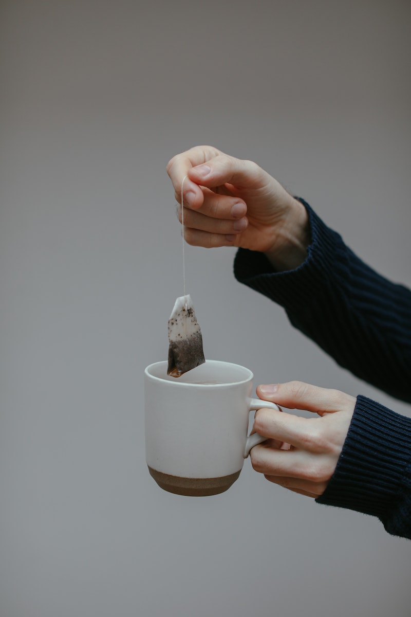 Close Up Photo of Tea Bag and a Cup
