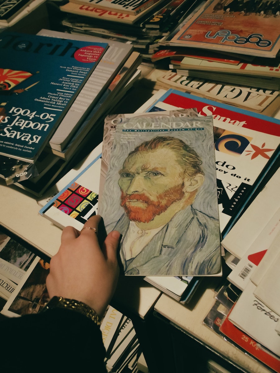 Woman Holding a Calendar in a Second Hand Bookstore