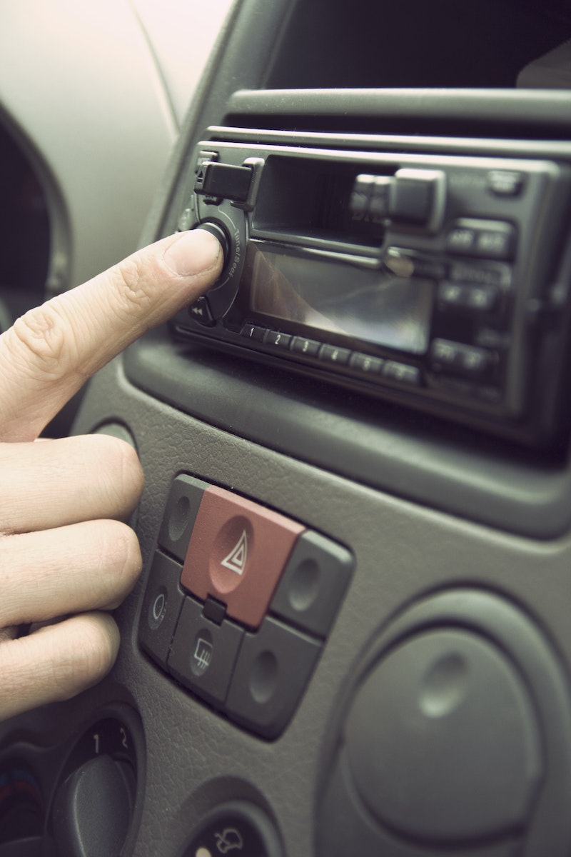 Person Touching 1-din Head Unit Button