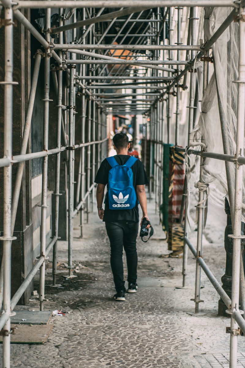 Man Standing Beside Pipes
