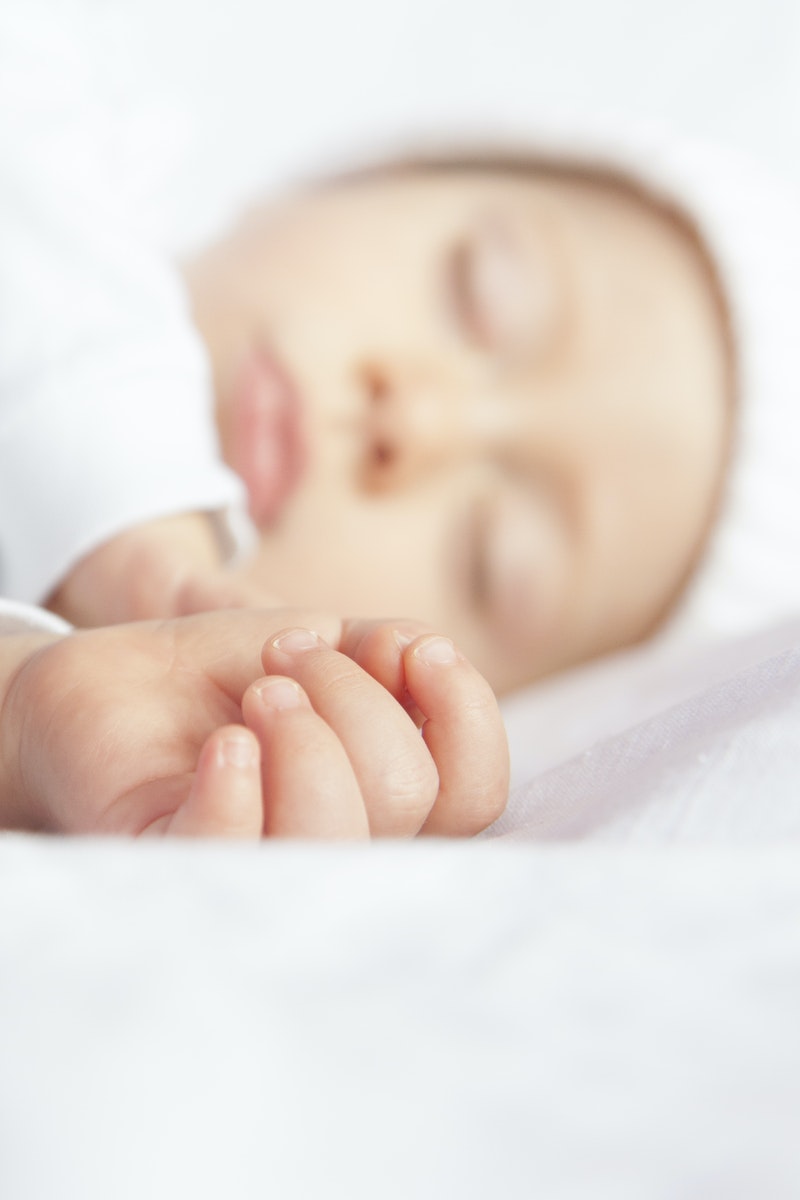 Baby Lying On White Textile