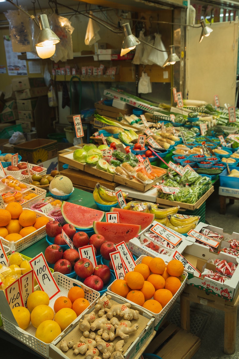 Colorful fruits and vegetables placed on counter in local market