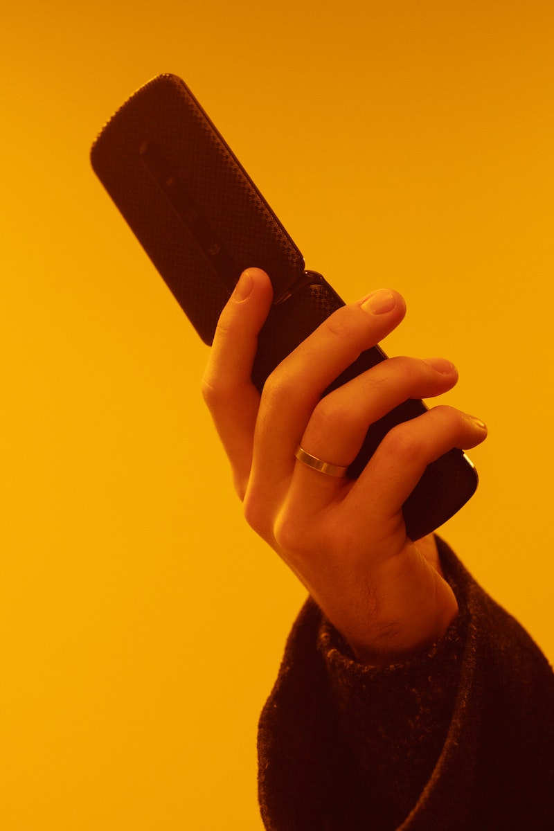 Person Holding a Flip Phone