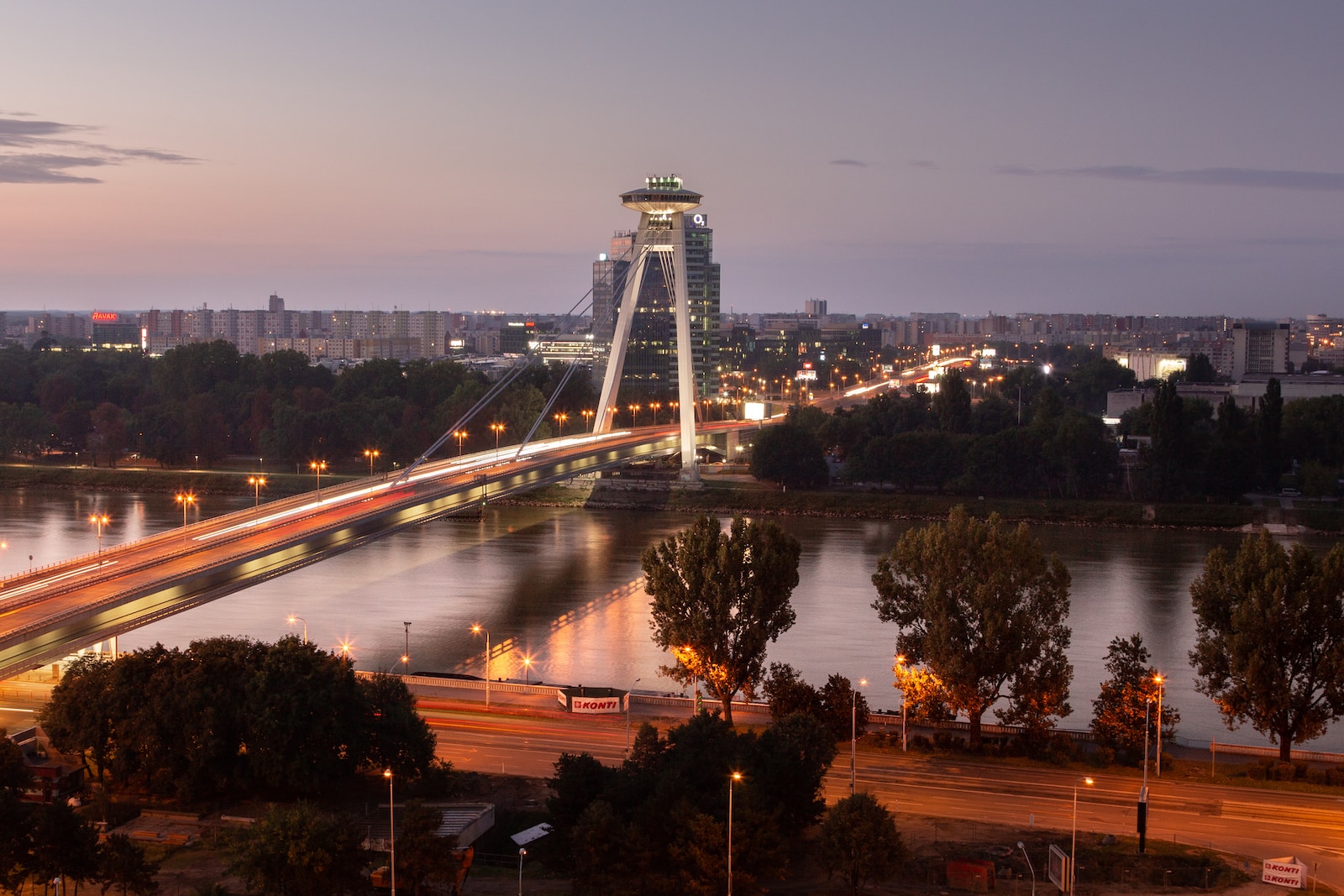 a view of a bridge over a river at night