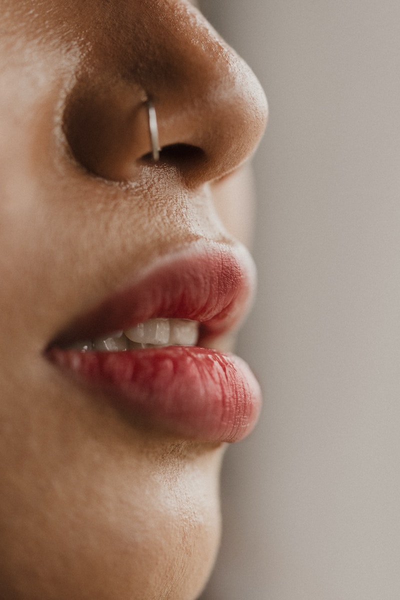 person wearing silver stud earring