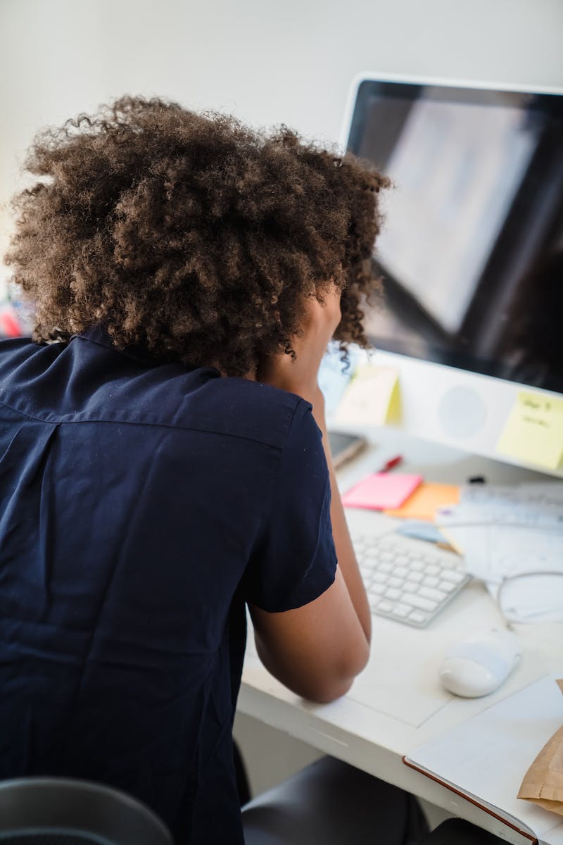 Frustrated and Stressed Businesswoman Sitting at a Desk