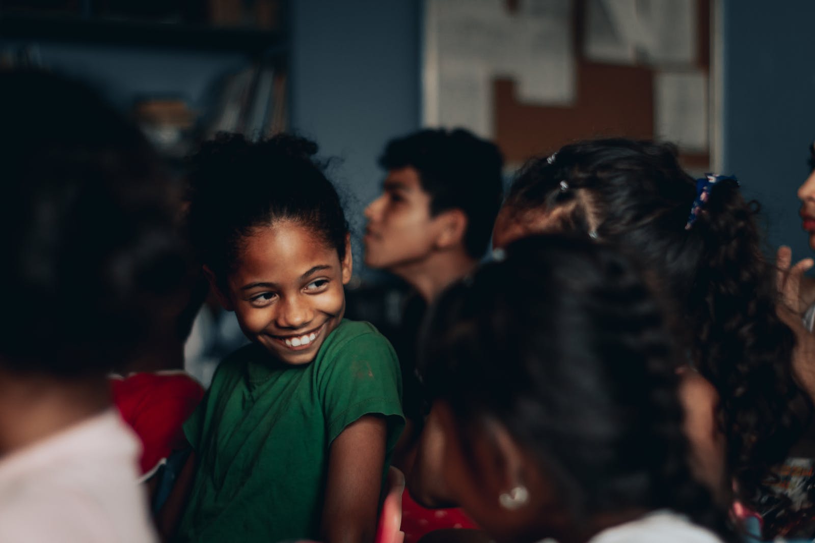 Content African American girl in casual wear chatting with girlfriends while visiting spectacle