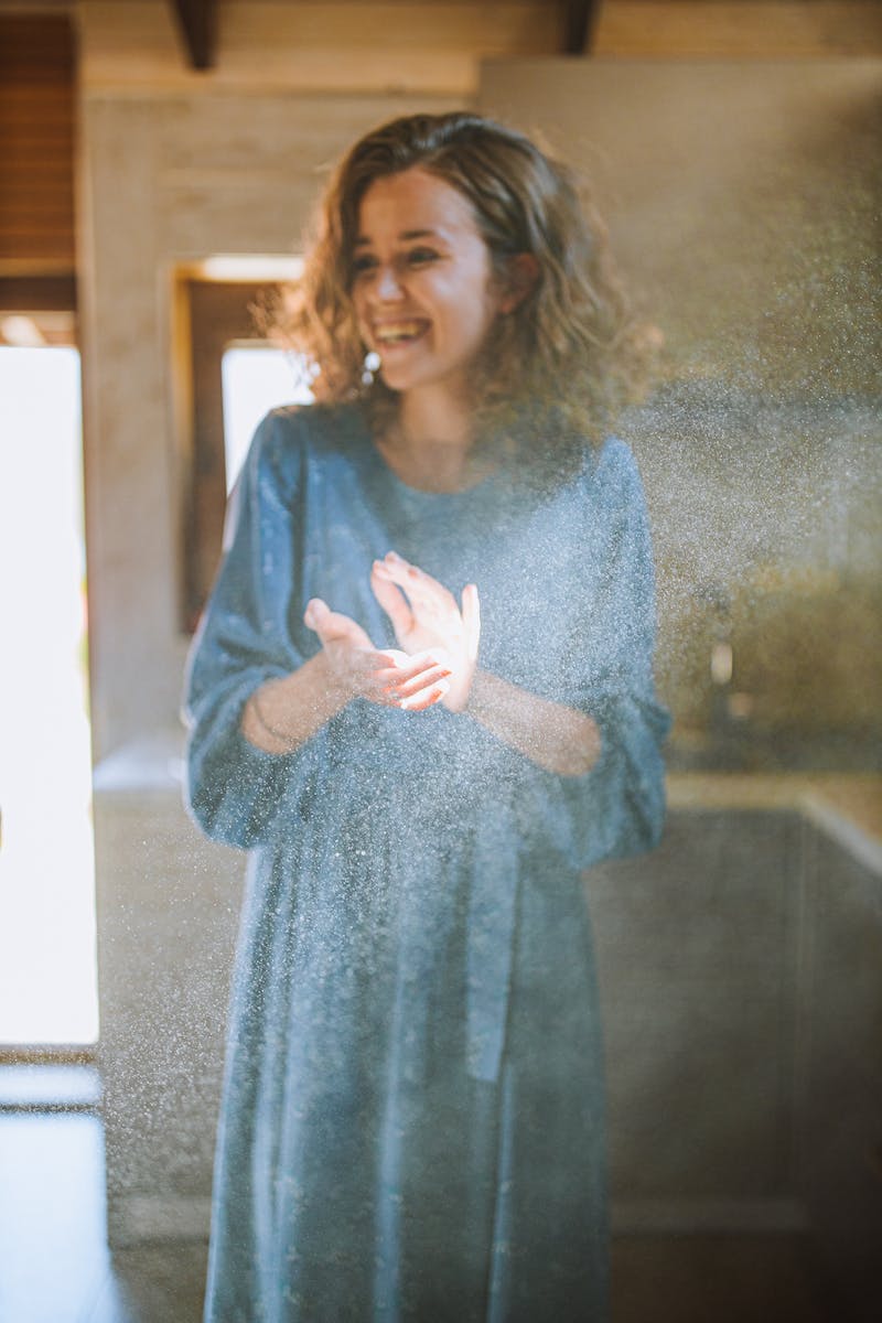 Woman in Blue Long Sleeve Dress Clapping