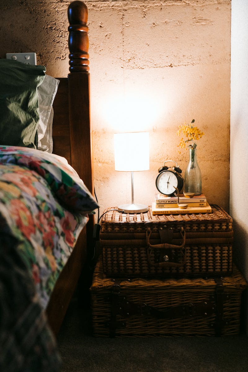 Bed and creative rustic furniture in evening