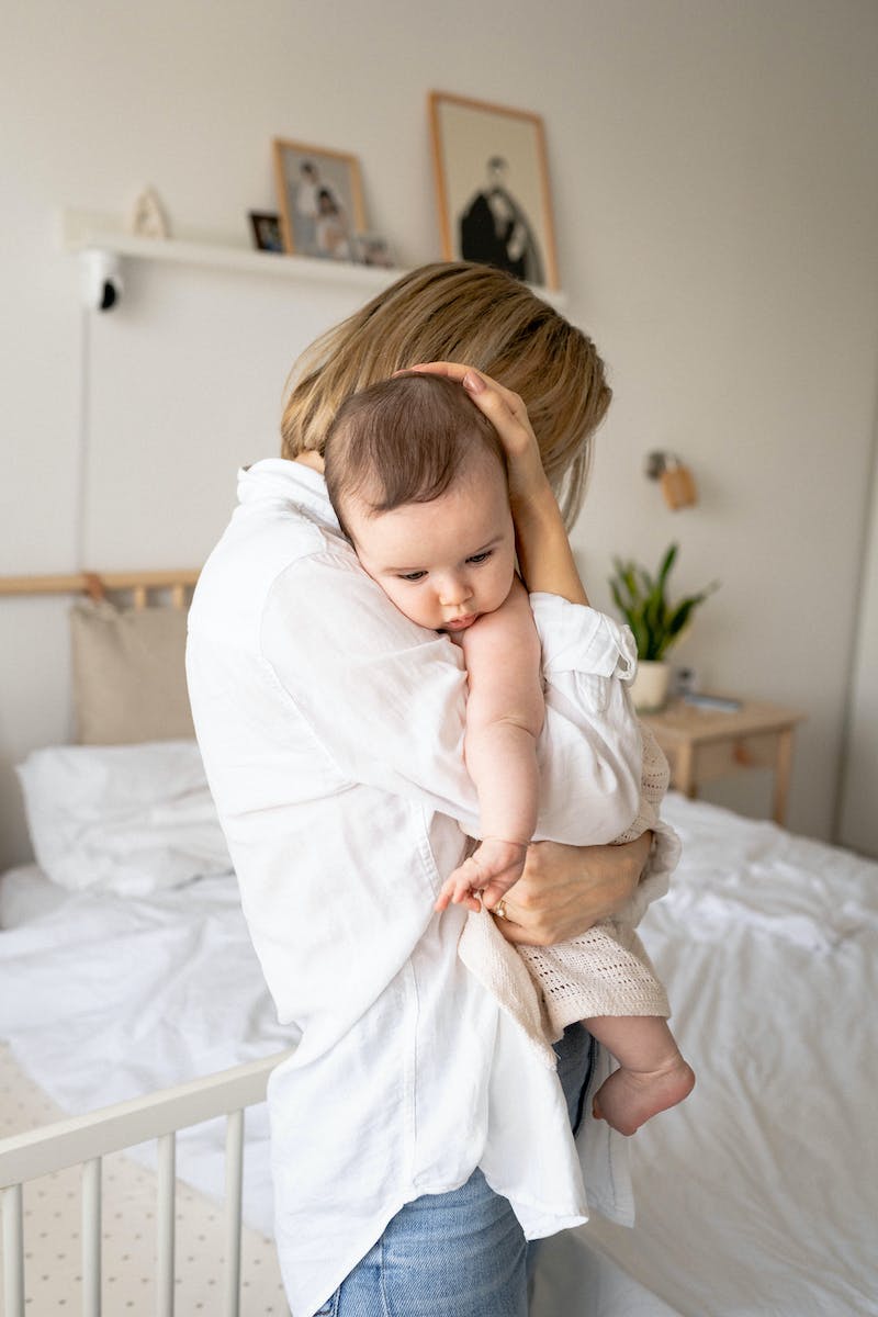 Mother Holding and Hugging Her Baby