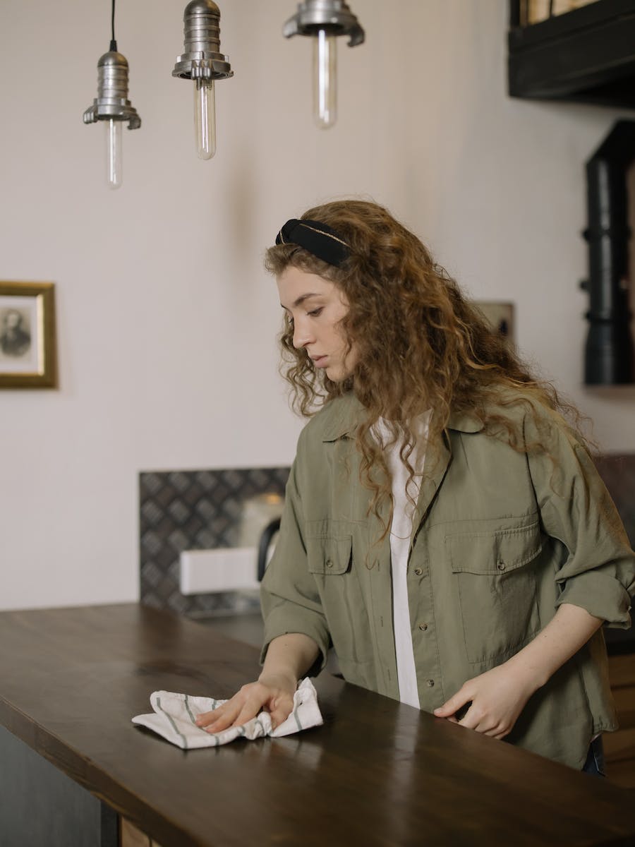 Woman in Brown Coat Sitting at the Table