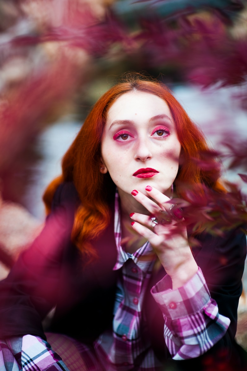 shallow focus photography of woman posing for photo