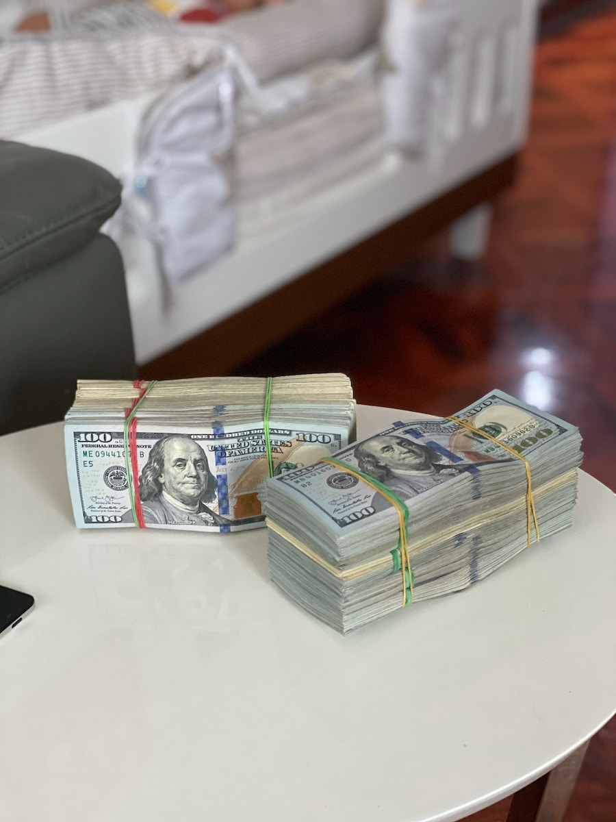 a stack of money sitting on top of a white table