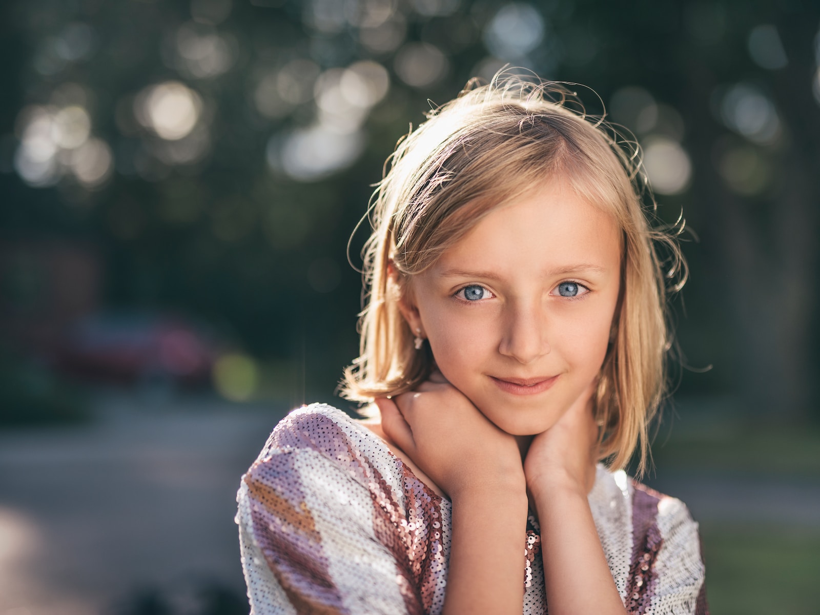 selective focus photography of girl in sequined white-and-pink stripe shirt