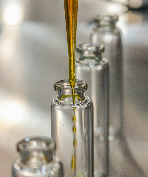 clear glass bottle with yellow liquid