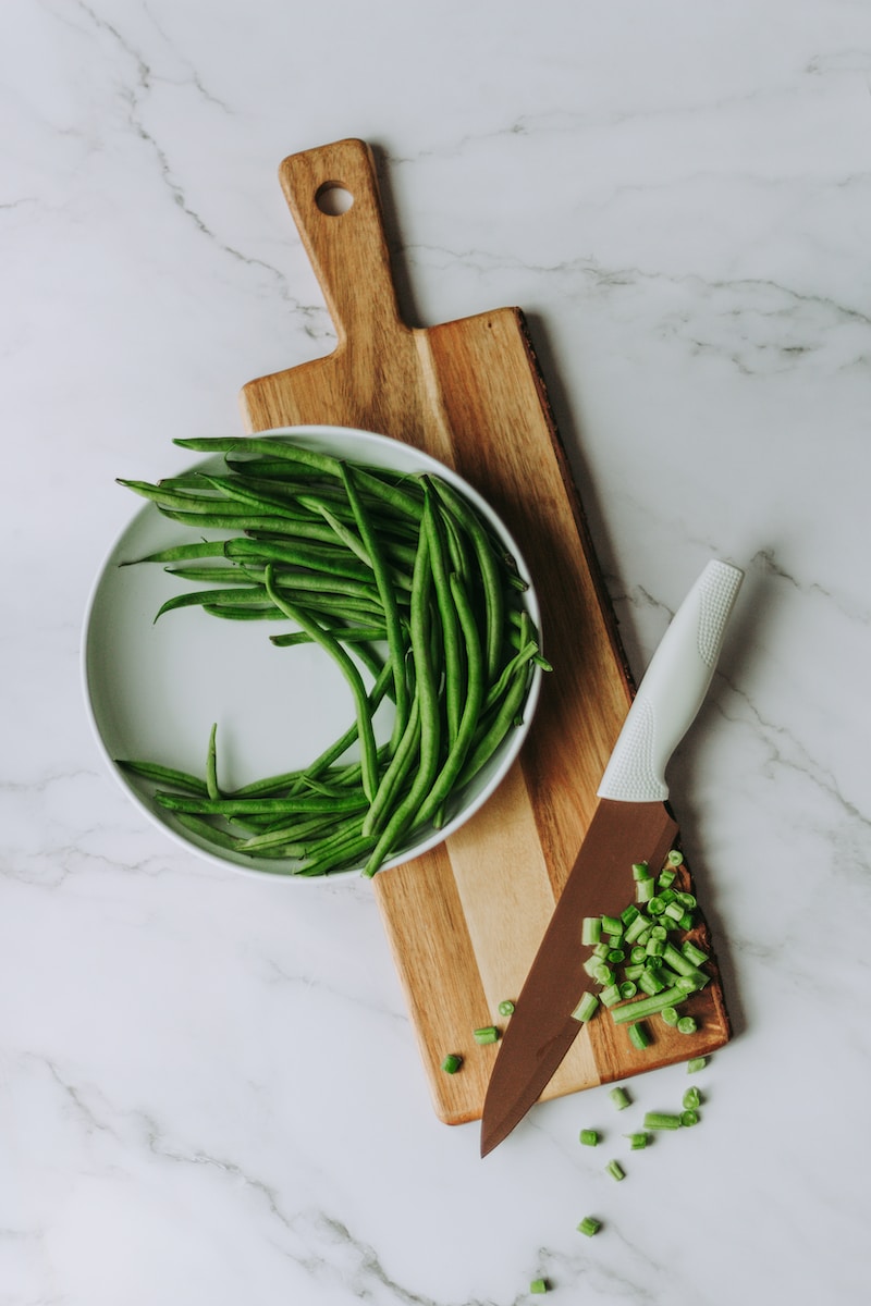 green and white vegetable on brown wooden chopping board