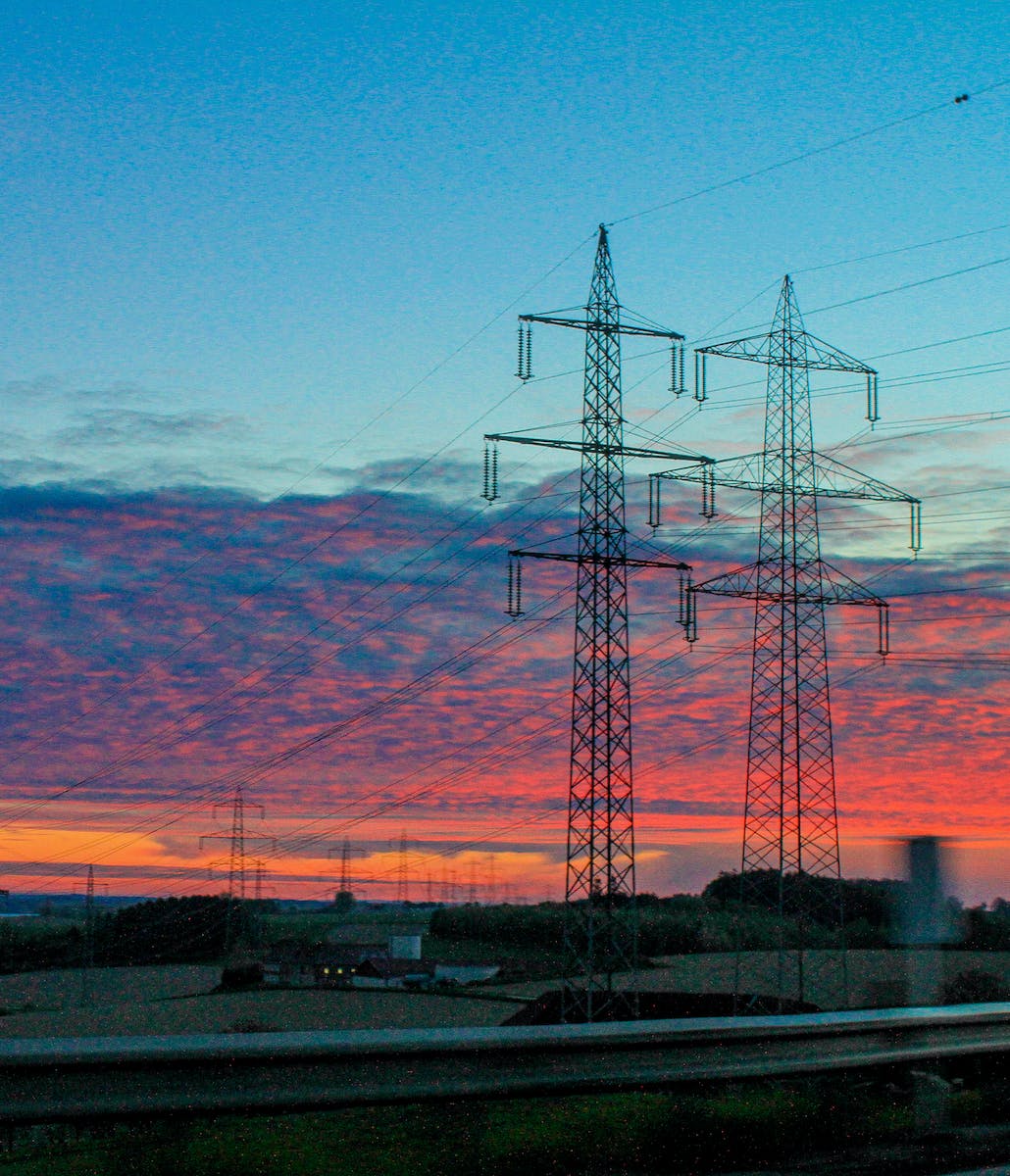 Black Electric Towers during Sunset
