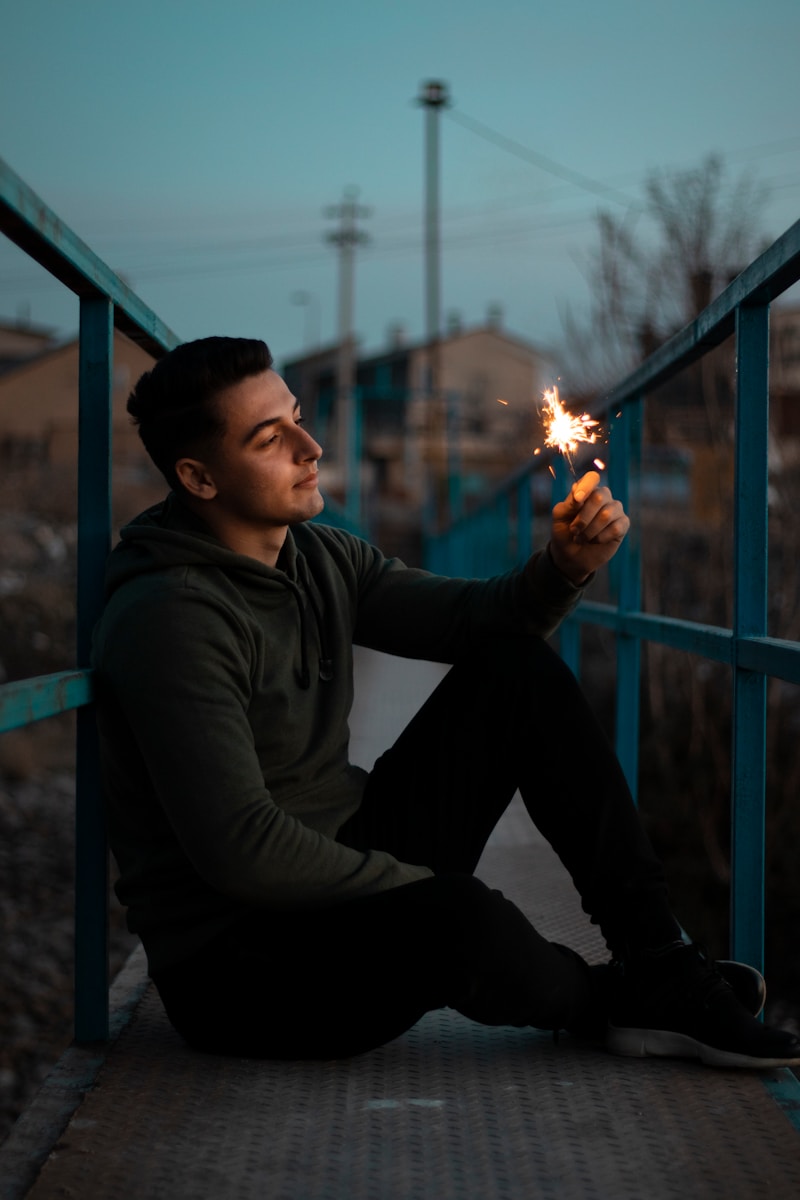 man in black long sleeve shirt holding fire