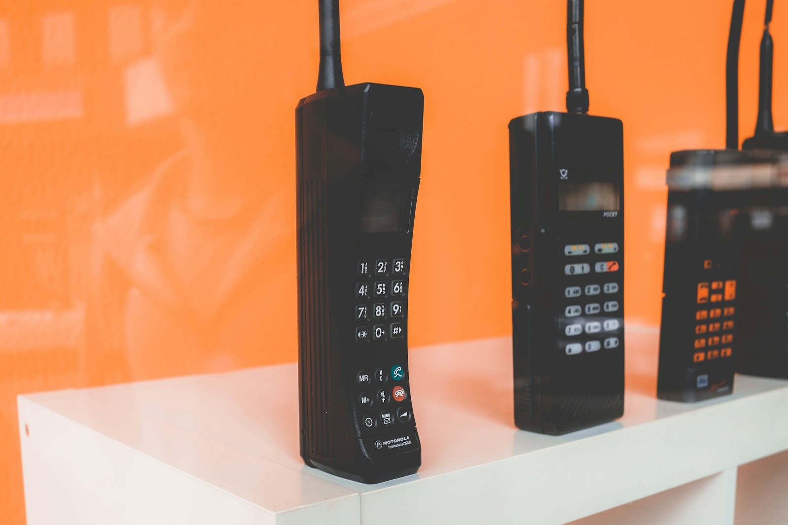 black home phones on white rac k