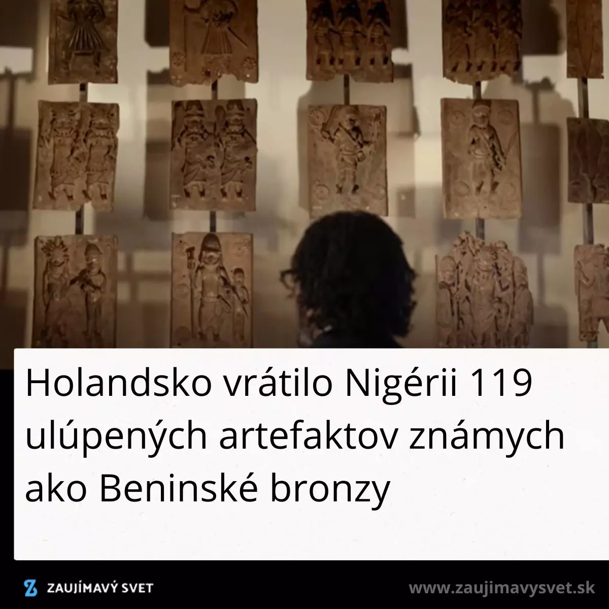 Osoba obdivuje Beninské bronzy v galérii po návrate do Nigérie, vystavené na stene v radoch.
